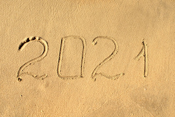 New year, number 2021 on beach sand. Holiday concept. 