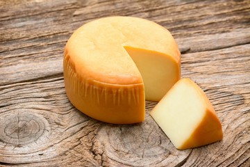 Cheese wheel on wooden table