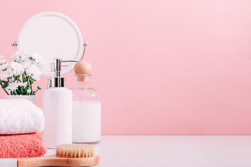 Soft light pink bathroom decor, design, set of cosmetic bottles, mirror, towel, soap dispenser....