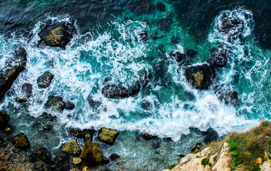 Aerial view on waves smashing on a cliff