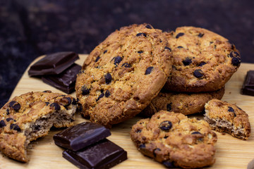 Freshly baked American chocolate chip cookies on rustic brown wooden table background