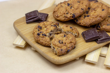 Freshly baked American chocolate chip cookies on rustic brown wooden table background