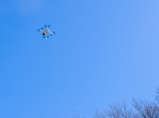 Small drone quadcopter in flight with digital camera