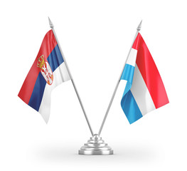 Luxembourg and Serbia table flags isolated on white 3D rendering