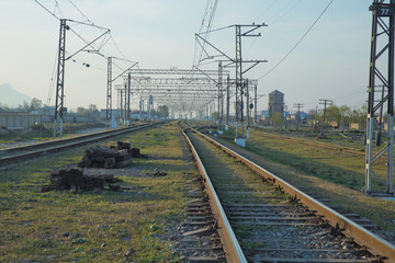 Fototapeta na wymiar Railroad tracks . Straight railway line . Empty summer railway . local railway and train station .