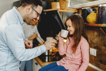 Happy father and daughter having fun in the kitchen.