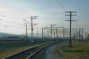 Railroad tracks . Straight railway line . Empty summer railway . local railway and train station .