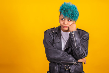 young modern brunette girl with curly blue hair of afro american ethnicity isolated on color background