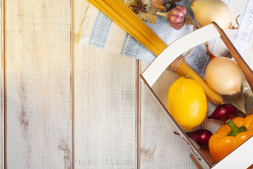 still life aromatic spices and pasta sprinkled on a white wooden table