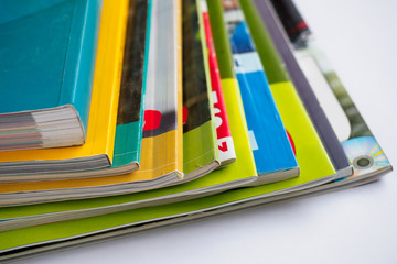 Stack of magazines on white background