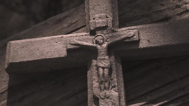 Cocle, Panama - December 04, 2017: Close up view, silver crucifix hanging.Stone cross with a crucifix with sunbeams