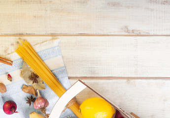 still life aromatic spices and pasta sprinkled on a white wooden table