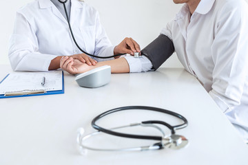 Close up of stethoscope, Image of Doctor using stethoscope checking measuring arterial blood pressure on arm to a patient in the hospital, healthcare and medical concept