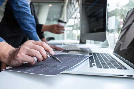 Team of developer programmer working on project in software development computer in IT company office, Writing codes and data code website and coding database technologies to find problem solution