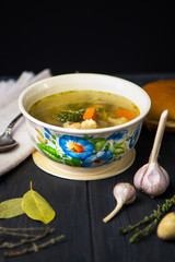 buckwheat green soup with chicken meat, broccoli and vegetables on a wooden background
