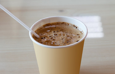 paper Cup with coffee, coffee foam, drinking straw