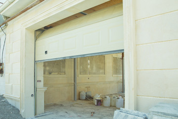 Shutter door or roller door and concrete floor outside .White Automatic shutters in a house . gates in the garage . Automatic Electric Roll-up Gate Or Push-up Door In  Building Ground Floor .