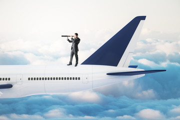 Businessman with telescope standing on airplane.