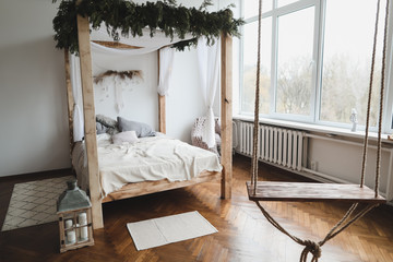 Spacious bedroom with bed against a wall. Bed with wooden canopy. Modern home interior design concept. scandinavian style © paralisart