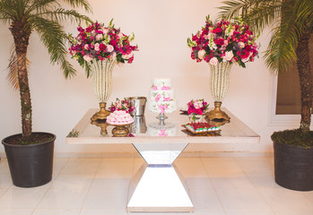 cake table decorated with flowers for wedding