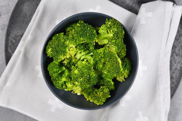 Top view of helathy steamed broccoli vegetables in dark bowl
