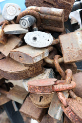 old rusty love locks on the bridge railing close up