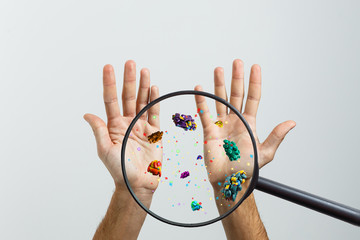 Close up on a sick man hand through magnifying glass transmitting virus by skin contact 3D rendering