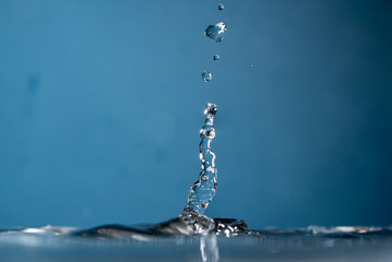 Water Drop falling making droplet splash and waves clean and fresh symbol.