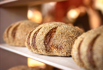 Sourdough bread with sesame seeds on a shelf. Healthy bread