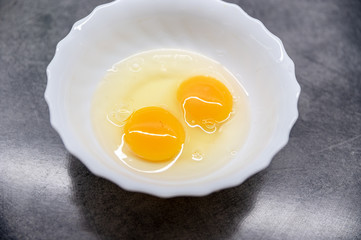 Fresh Egg With Bowl of Egg White on grey Table, Food Style.