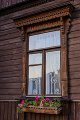 Fototapeta na wymiar Window in a wooden old house with different loot