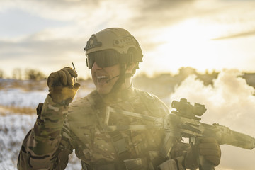 Modern war soldier army Man in multicam camouflage speaks on the walkie-talkie radio. equipment...