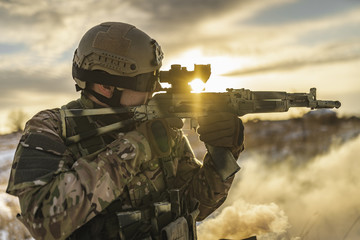 Ukrainian soldier in a fighting shootout with Russians in the winter field. Ukraine Russian...