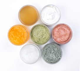 Set of cans of cream of various colors isolated on white background