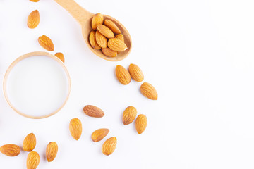 Almond milk with almond on white background. Homemade organic almond milk in a paper cup for healthy breakfast. Vegan milk from almonds nuts in kraft paper cup. Alternative milk. Zero waste
