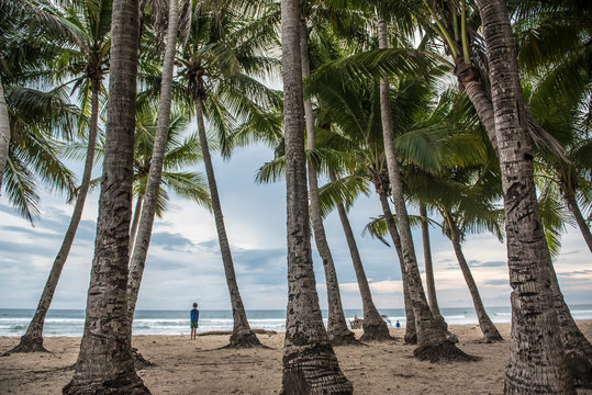 A boy stands on the beach at Playa Grande Costa Rica