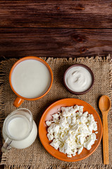 Homemade fermented milk products - kefir, cottage cheese on a wooden background.