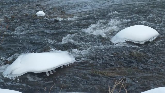Spring forest river. Melting ice on the river, white snow on the river banks