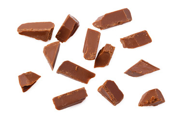 milk chocolate broken into pieces isolated on a white background. top view