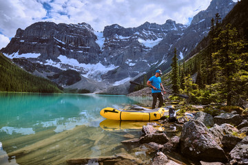 A man assembles prepares for a rafting trip across Cirque Lake, Banff