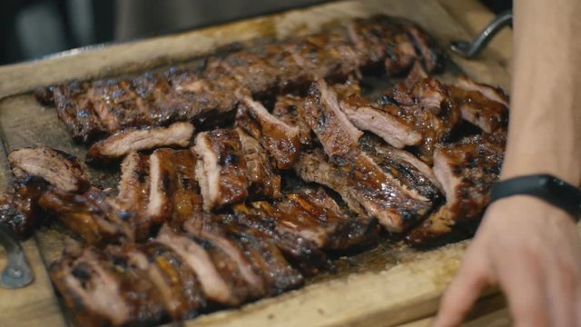 waiter cuts fried pork ribs