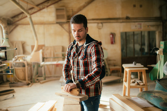 Young Handsome Carpenter Flattening Wood