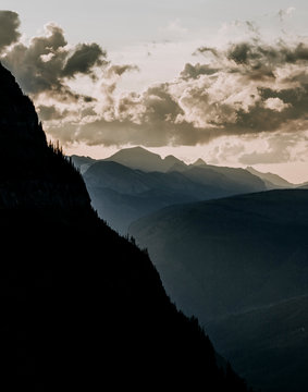 view of steep mountain and clouds at sunset, Glacier Park, Montana