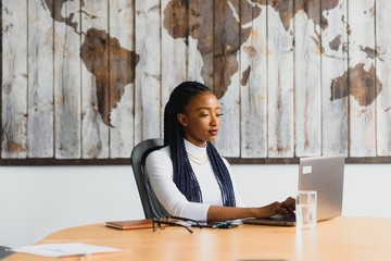 beautiful young african american businesswoman working on computer
