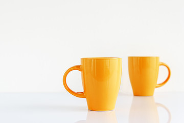 Two yellow coffee cups mock up