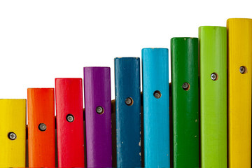Multicolored dies of a xylophone musical instrument, similar to an increasing graph, on a white...