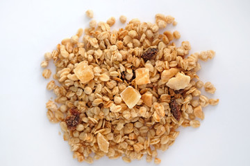 Muesli with raisins nuts and candied fruits. Dry granola mix on a white background top view.