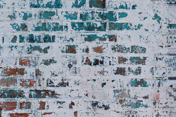 Gray background old plastered brick wall with elements of blue paint