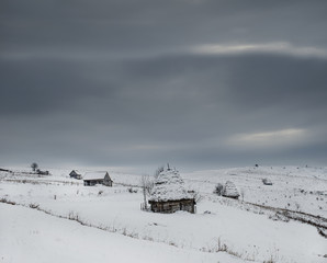 Traditional houses in Dumesti village, Apuseni Mountains, Romania, in winter