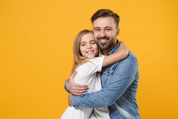 Smiling bearded man in casual clothes hugging with cute child baby girl. Father, little kid daughter isolated on yellow orange background studio portrait. Love family day parenthood childhood concept.